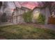 Exterior view of a charming home with a well-manicured lawn under a beautiful sunset sky at 4032 S Lisbon Way, Aurora, CO 80013