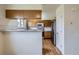Bright kitchen featuring modern appliances, a breakfast bar, and hardwood floors at 4032 S Lisbon Way, Aurora, CO 80013