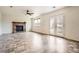 Living room features a brick fireplace, fan, and french doors for indoor/outdoor living at 4032 S Lisbon Way, Aurora, CO 80013