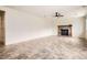 Spacious living room area with a fireplace and a fan at 4032 S Lisbon Way, Aurora, CO 80013