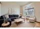 Cozy living room featuring a comfortable sofa set, accent chairs, and a decorative wall art arrangement at 4032 S Lisbon Way, Aurora, CO 80013