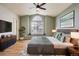 Beautiful primary bedroom with a ceiling fan, large window, and hardwood flooring at 4032 S Lisbon Way, Aurora, CO 80013