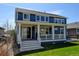 Relaxing backyard with a covered porch, steps leading to the lawn, and elegant architectural detailing at 18315 W 83Rd Dr, Arvada, CO 80007