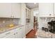 Well-organized butler's pantry with granite countertops, custom cabinetry, and modern finishes at 18315 W 83Rd Dr, Arvada, CO 80007