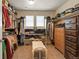 Spacious walk-in closet with built-in shelving, drawers, and a bench for storage and organization at 18315 W 83Rd Dr, Arvada, CO 80007