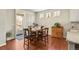 Bright dining area features hardwood floors, an outdoor view, and stylish decor at 18315 W 83Rd Dr, Arvada, CO 80007