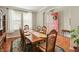 Formal dining room with hardwood floors, a large wooden table, and views of the front entry at 18315 W 83Rd Dr, Arvada, CO 80007