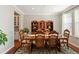 Elegant dining room with wood furniture, complemented by a patterned rug and natural light at 18315 W 83Rd Dr, Arvada, CO 80007