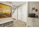 Inviting foyer with tile flooring, decorative bench, staircase, and convenient storage at 18315 W 83Rd Dr, Arvada, CO 80007
