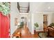 Inviting foyer with gleaming hardwood floors, a red front door, and a view of the upper level at 18315 W 83Rd Dr, Arvada, CO 80007