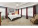 Spacious main bedroom with tray ceiling, plush carpet, and natural light from many windows at 18315 W 83Rd Dr, Arvada, CO 80007