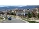 Charming street view showcases well-maintained homes, manicured lawns, and picturesque mountain views in the background at 18315 W 83Rd Dr, Arvada, CO 80007