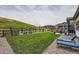 Expansive backyard with a lush lawn, patio area, comfortable lounge chairs, and a scenic view of the surrounding community at 5668 Shadescale Way, Castle Rock, CO 80104
