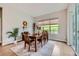 Bright dining room with wood floors, large window and seating for six at 5668 Shadescale Way, Castle Rock, CO 80104