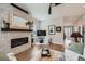 Cozy living room with a tiled fireplace, hardwood floors, and neutral decor at 5668 Shadescale Way, Castle Rock, CO 80104