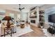 Bright living room with a stylish fireplace, hardwood floors, and modern decor at 5668 Shadescale Way, Castle Rock, CO 80104