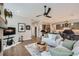 Open-concept living room with hardwood floors and views of the kitchen at 5668 Shadescale Way, Castle Rock, CO 80104