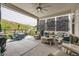 Covered outdoor patio boasts comfortable seating, an outdoor kitchen, and stunning views of the surrounding landscape at 5668 Shadescale Way, Castle Rock, CO 80104