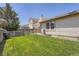 Private backyard with green grass and mature trees providing shade and tranquility at 4548 Gibraltar Way, Denver, CO 80249