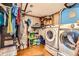Unfinished basement featuring a laundry area with a washer and dryer and storage space at 4548 Gibraltar Way, Denver, CO 80249