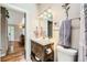 Bathroom showcasing a modern vanity and fixtures, with an open view to the hallway at 4548 Gibraltar Way, Denver, CO 80249