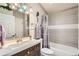 Bathroom featuring modern vanity and fixtures, decorative mirror and a shower-tub combo at 4548 Gibraltar Way, Denver, CO 80249