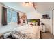 Basement bedroom featuring carpet floors, egress window, side tables, and closet at 4548 Gibraltar Way, Denver, CO 80249