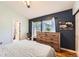 Bedroom featuring wood floors, a large window, an ensuite bathroom, and closet at 4548 Gibraltar Way, Denver, CO 80249