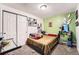 Bedroom with unique decor, featuring a comfortable bed and ample closet space at 4548 Gibraltar Way, Denver, CO 80249