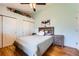 Bright bedroom with wood floors, dual closets, side tables, and a ceiling fan at 4548 Gibraltar Way, Denver, CO 80249