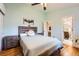 Bright bedroom with wood floors, side tables, dual closets, and an ensuite bathroom at 4548 Gibraltar Way, Denver, CO 80249