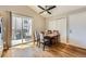 Light-filled dining room with hardwood floors, a ceiling fan, and sliding glass doors to the outside at 4548 Gibraltar Way, Denver, CO 80249