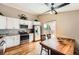 Modern kitchen with stainless steel appliances, granite countertops, and a dining area at 4548 Gibraltar Way, Denver, CO 80249
