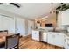Updated kitchen featuring white cabinets, stainless steel appliances, and wood floors at 4548 Gibraltar Way, Denver, CO 80249