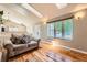 Living room with wood floors and a large window, offering plenty of natural light at 4548 Gibraltar Way, Denver, CO 80249