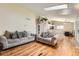 Open-concept living room with wood floors, two sofas, and natural light at 4548 Gibraltar Way, Denver, CO 80249