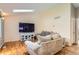Cozy living room with wood floors, a large television, and comfortable seating at 4548 Gibraltar Way, Denver, CO 80249
