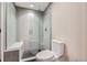 Modern bathroom with a frameless glass shower, rain shower head, and black and white tile flooring at 8280 Bannock Dr, Larkspur, CO 80118