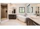 Bathroom featuring double vanity, soaking tub, a walk-in shower with unique tile, and black window frames at 8280 Bannock Dr, Larkspur, CO 80118