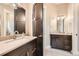 Beautiful bathroom with double sinks, quartz countertop, dark cabinets, and stylish lighting at 8280 Bannock Dr, Larkspur, CO 80118
