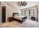 Serene bedroom with plush carpet, a ceiling fan, and a large window at 8280 Bannock Dr, Larkspur, CO 80118