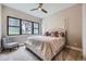 Bright bedroom with plush carpet, upholstered bed frame and large window with views at 8280 Bannock Dr, Larkspur, CO 80118