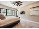 Cozy bedroom with plush carpet, a large window, and a ceiling fan at 8280 Bannock Dr, Larkspur, CO 80118