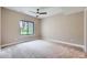 Empty bedroom featuring carpet, neutral walls, base trim and window at 8280 Bannock Dr, Larkspur, CO 80118
