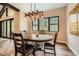 Charming dining area with a wood table and natural light from a large window at 8280 Bannock Dr, Larkspur, CO 80118