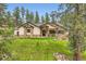 Beautiful home with stone accents and a manicured lawn provides a charming curbside appeal at 8280 Bannock Dr, Larkspur, CO 80118