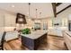 Gourmet kitchen with large island, stainless steel appliances, and modern lighting for culinary enthusiasts at 8280 Bannock Dr, Larkspur, CO 80118