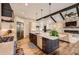 Open kitchen with large island and stainless steel appliances, connected to the living room at 8280 Bannock Dr, Larkspur, CO 80118