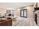 Cozy living room with carpet, stone fireplace, sliding door, and lots of seating at 8280 Bannock Dr, Larkspur, CO 80118