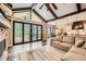 The living room offers access to an outdoor patio, dining area, and flows into the kitchen at 8280 Bannock Dr, Larkspur, CO 80118